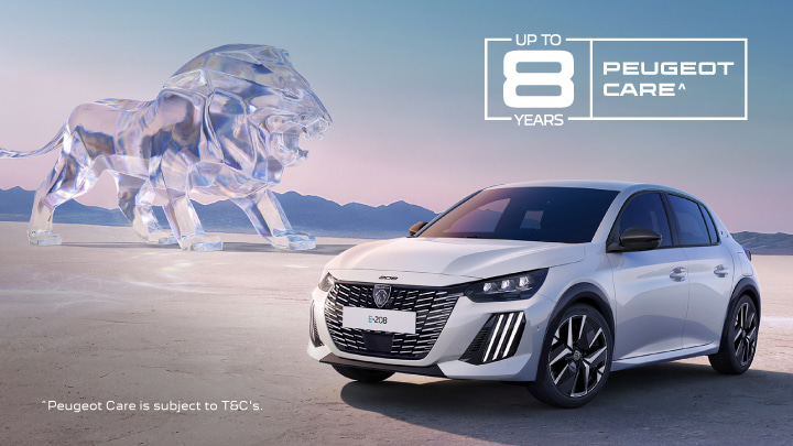 White Peugeot E-208 parked in front of a glass looking lion