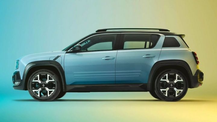 Side of a new Renault 4 parked on a blue and yellow background lit