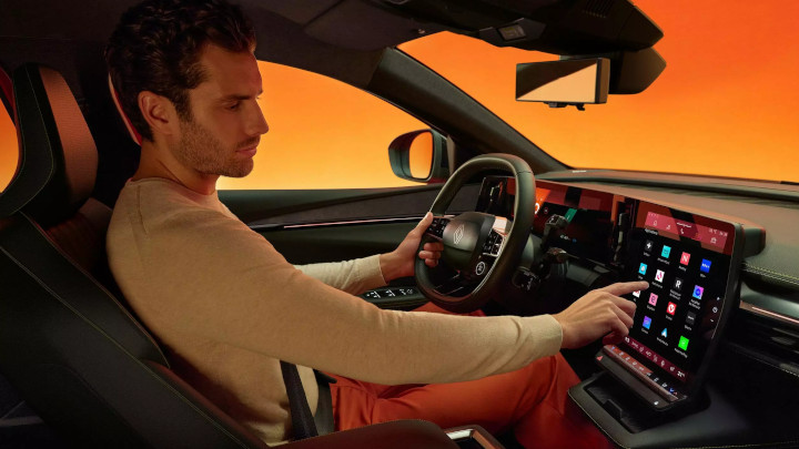 Man Sitting Inside Renault Megane E-Tech Interacting With Touchscreen