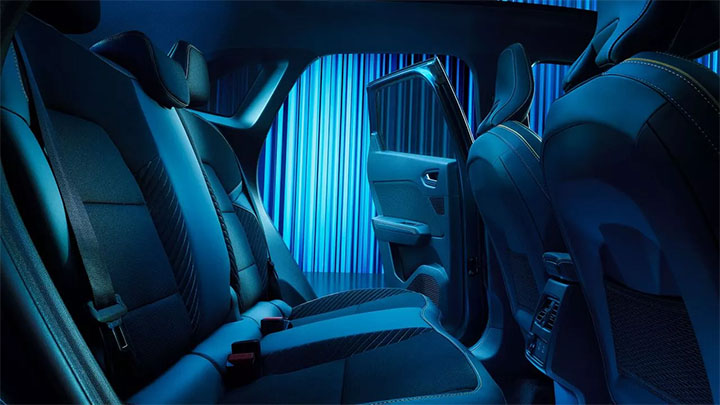 Interior side shot of a Renault Symbioz's rear seats, looking through an open door