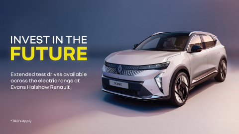 Silver Renault Scenic parked in a blue and white background