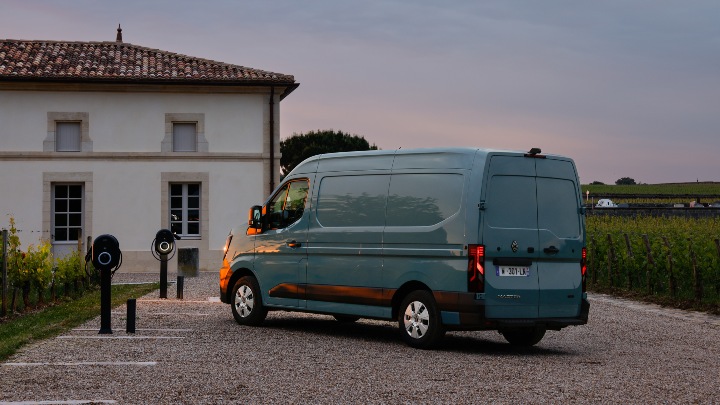 Renault Master E‑Tech electric van parked near charging points at sunset