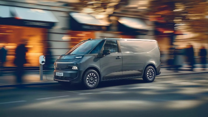 Renault Trafic Van E‑Tech electric van driving through an urban street environment