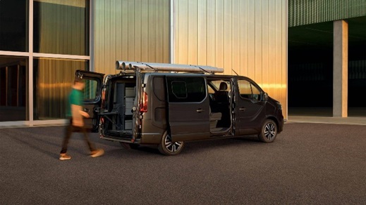 Renault Trafic van with side door open, showing practical loading access outside a modern building