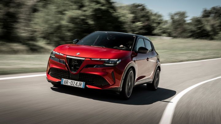 Red Alfa Romeo driving on the road
