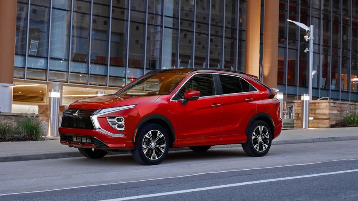 Red Mitsubishi Eclipse driving on the road