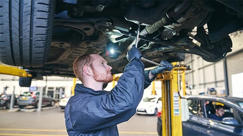 technician performing a vehicle health check