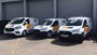 fleet of vans with matching vinyl graphics