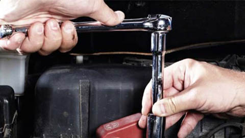 technician tightening bolt using ratchet