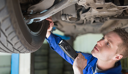 Vehicle Technician servicing a car.