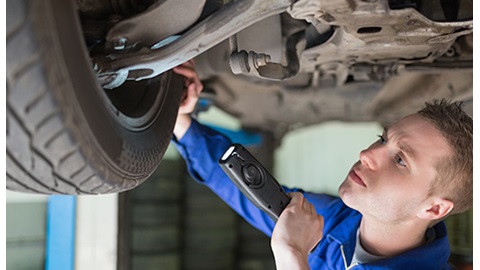 Vehicle Technician servicing a car.