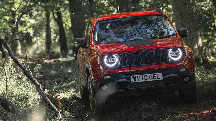 Red Jeep Renegade, off-roading with daytime running lights on