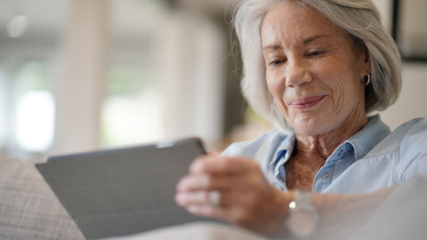 Elderly Woman Smiling on Tablet