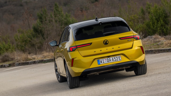 Yellow Vauxhall Astra rear driving
