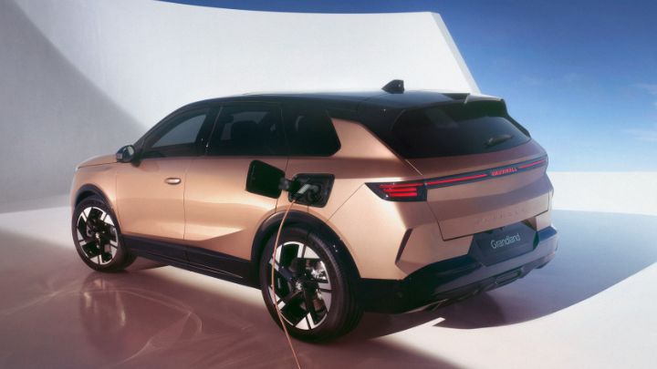 Rear end of Vauxhall Grandland facing the camera. The vehicle is being charged and the background is white and blue.