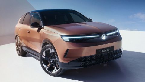 Front of Vauxhall Grandland facing the camera. The vehicle is being charged and the background is white and blue.