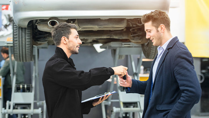 Vauxhall technician handing keys to customer