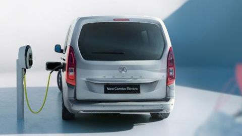 Silver Vauxhall Combo being charged in front of a white background