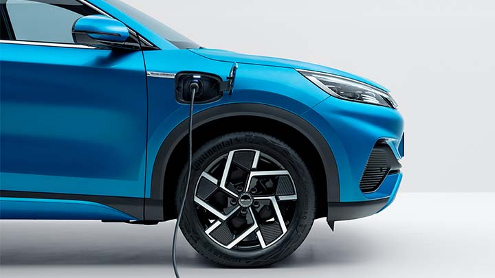 Blue BYD ATTO 3 charging, white background studio shot