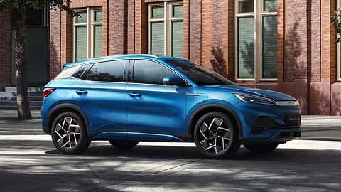 Blue BYD ATTO 3 driving in an urban environment