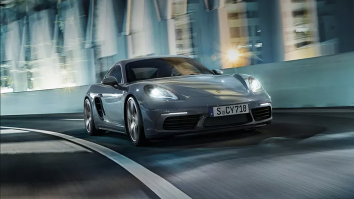 Porsche 718 driving on the road.