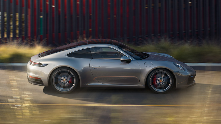 Grey Porsche 911 driving on the road.